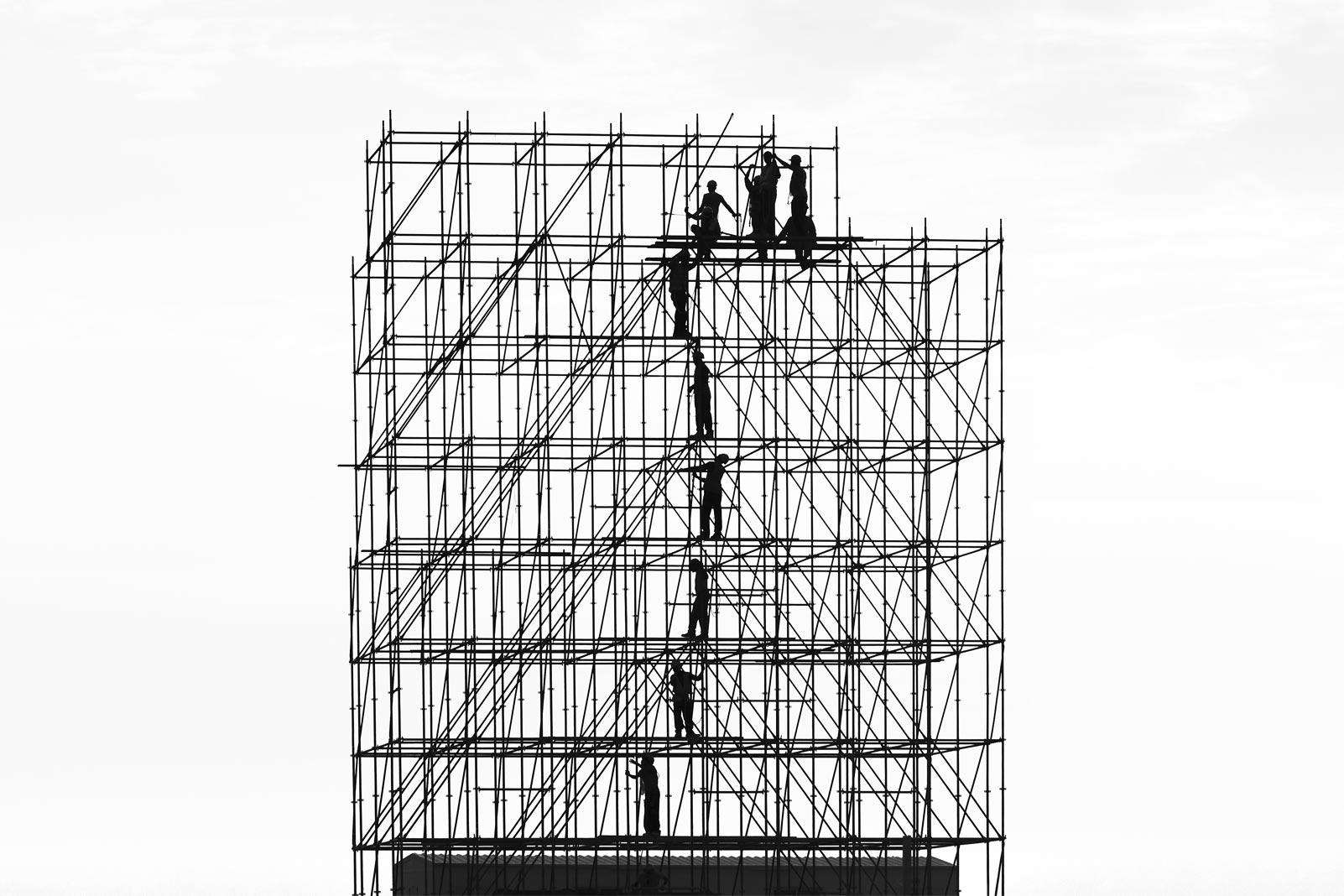 Construction crew assembling scaffold structure