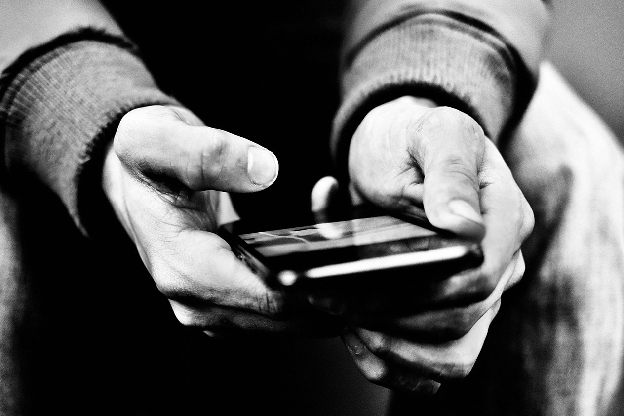 Close up of a man's hands holding a smart phone