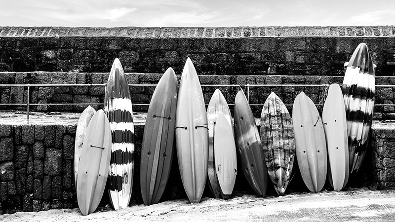 Surfboards stacked next to each other