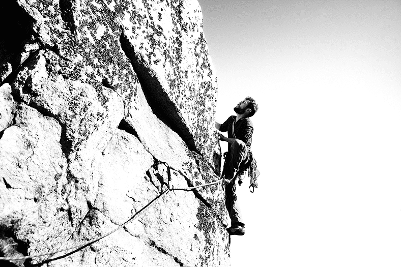 Image of a man rock climbing.